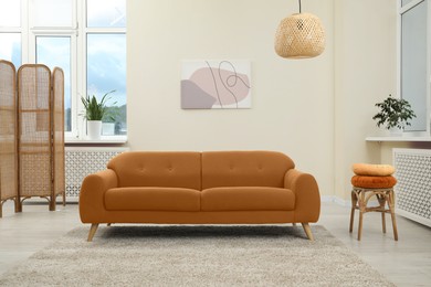Image of Living room with brown sofa and other furniture. Interior design