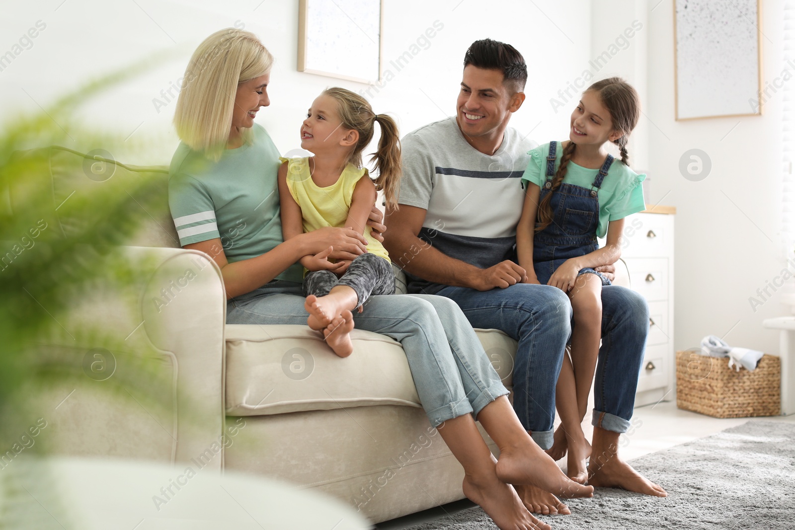 Photo of Happy family with children on sofa indoors