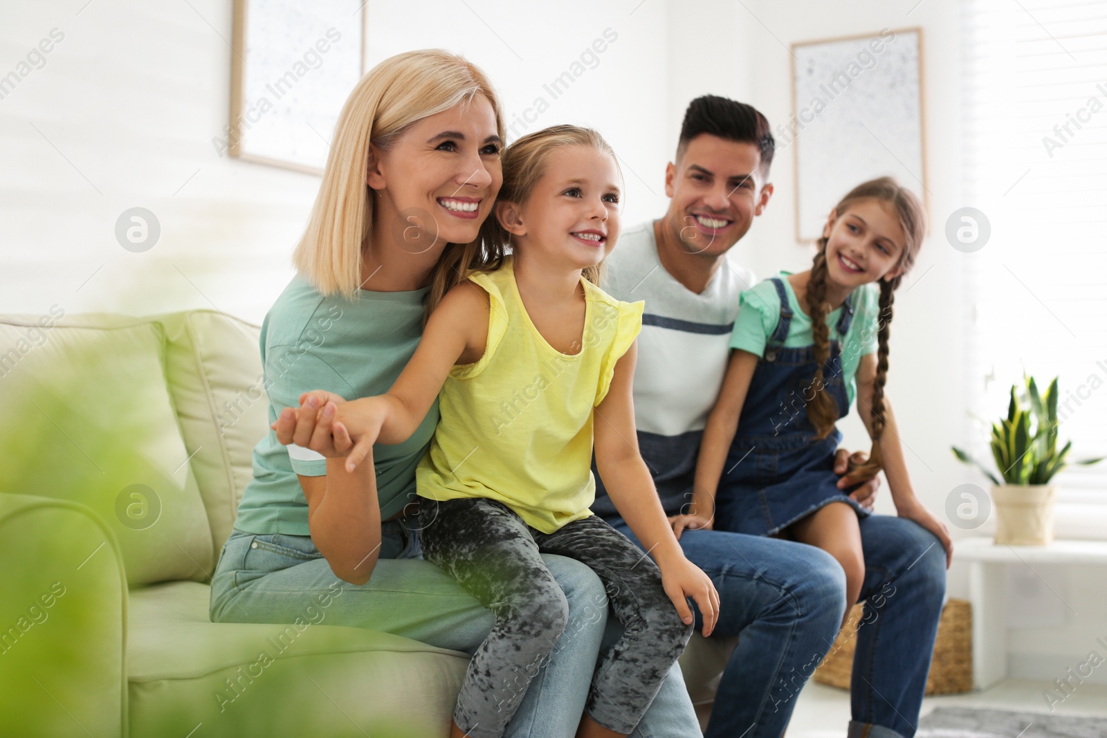 Photo of Happy family with children on sofa indoors