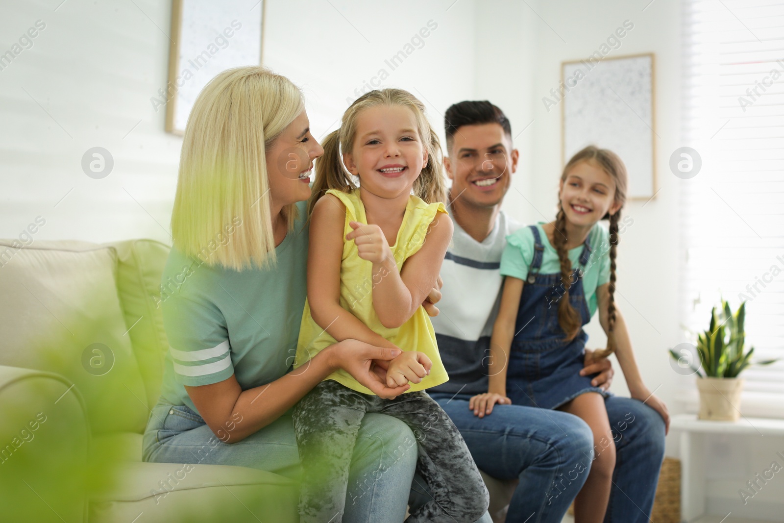 Photo of Happy family with children on sofa indoors