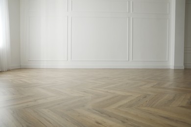 Photo of Parquet floor in light spacious empty room