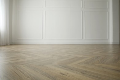 Photo of Parquet floor in light spacious empty room