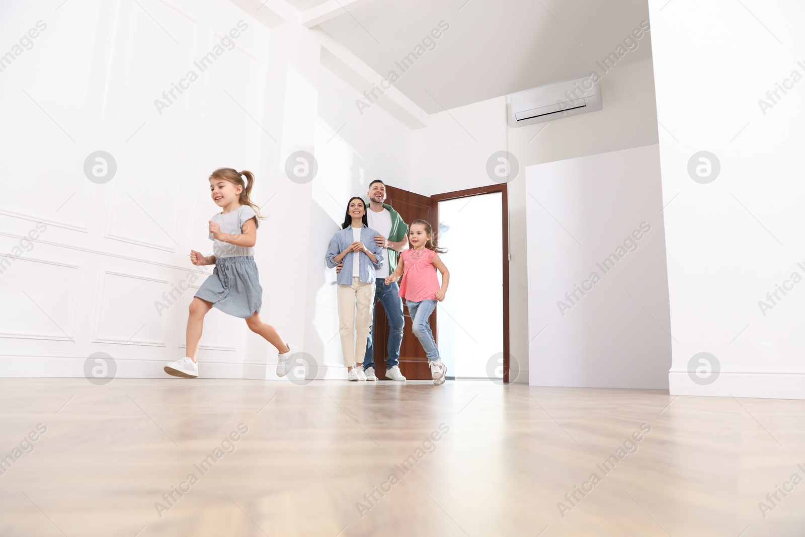 Photo of Happy family in their new house on moving day, low angle view