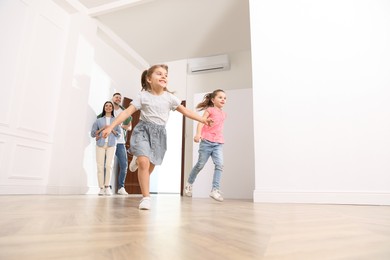 Photo of Happy family in their new house on moving day, low angle view