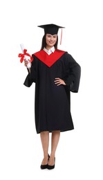 Photo of Happy young woman in graduation gown and mortarboard with diploma on white background