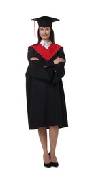 Photo of Young woman in graduation gown and mortarboard on white background