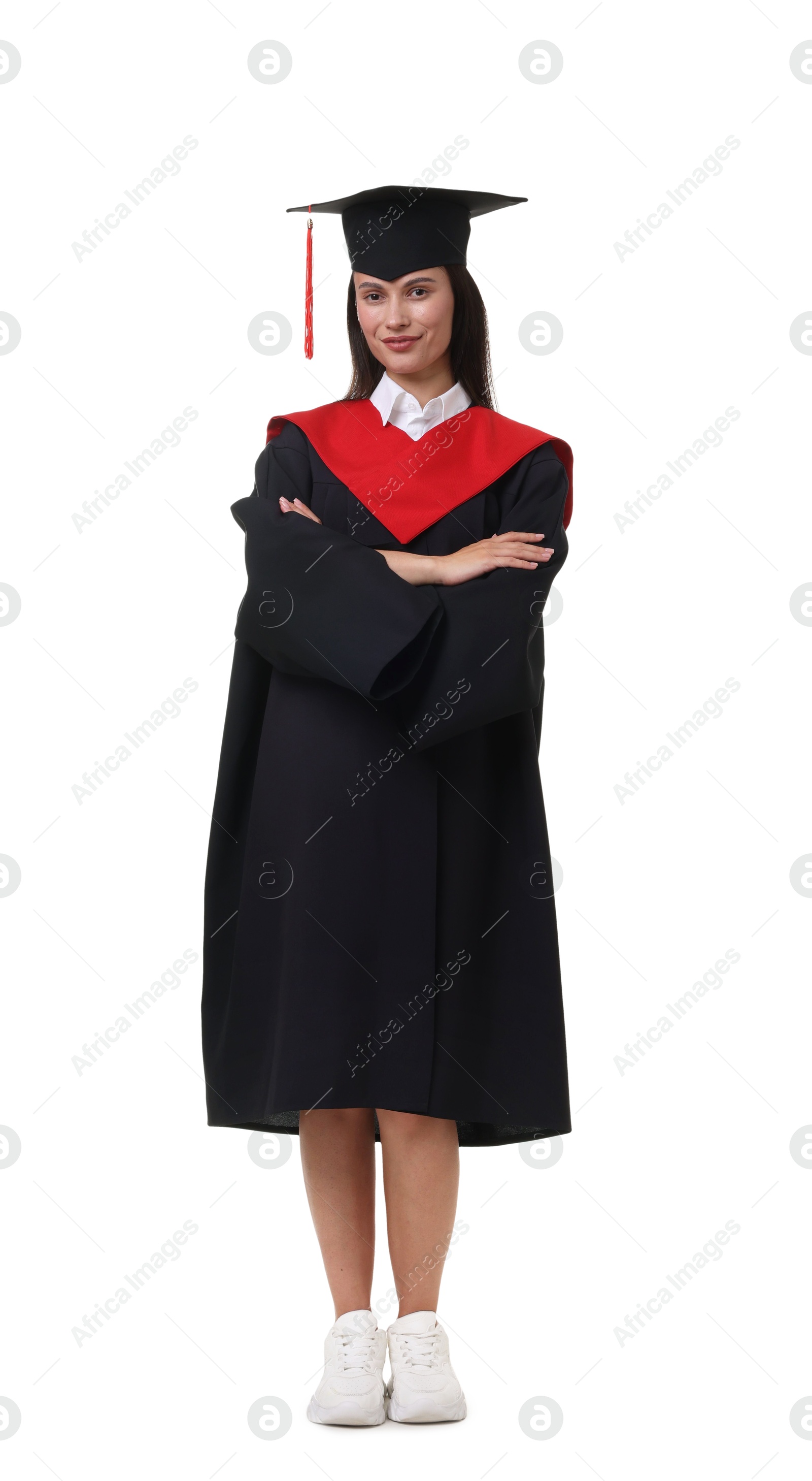 Young woman in graduation gown and mortarboard on white background Photo of Young woman in graduation gown and mortarboard on white background