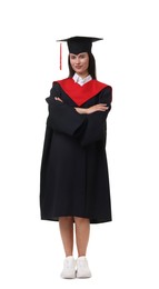 Photo of Young woman in graduation gown and mortarboard on white background