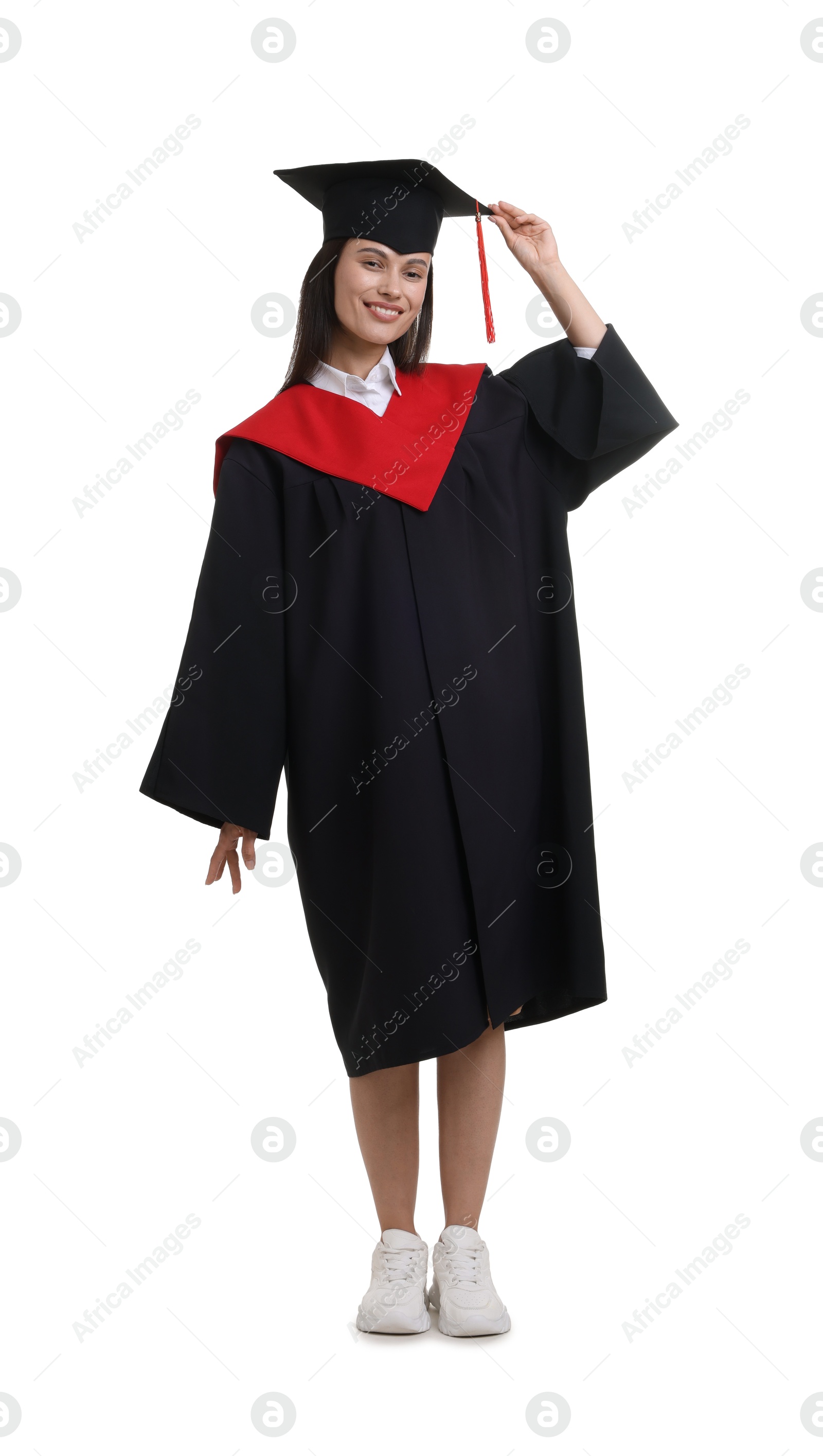 Photo of Happy young woman in graduation gown and mortarboard on white background