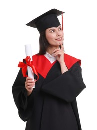 Photo of Portrait of happy young woman in graduation gown and mortarboard with diploma on white background