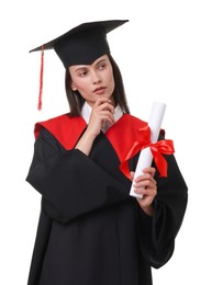 Photo of Portrait of thoughtful young woman in graduation gown and mortarboard with diploma on white background