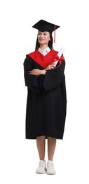 Photo of Happy young woman in graduation gown and mortarboard with diploma on white background