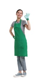 Photo of Gardener in apron and gloves showing ok gesture on white background