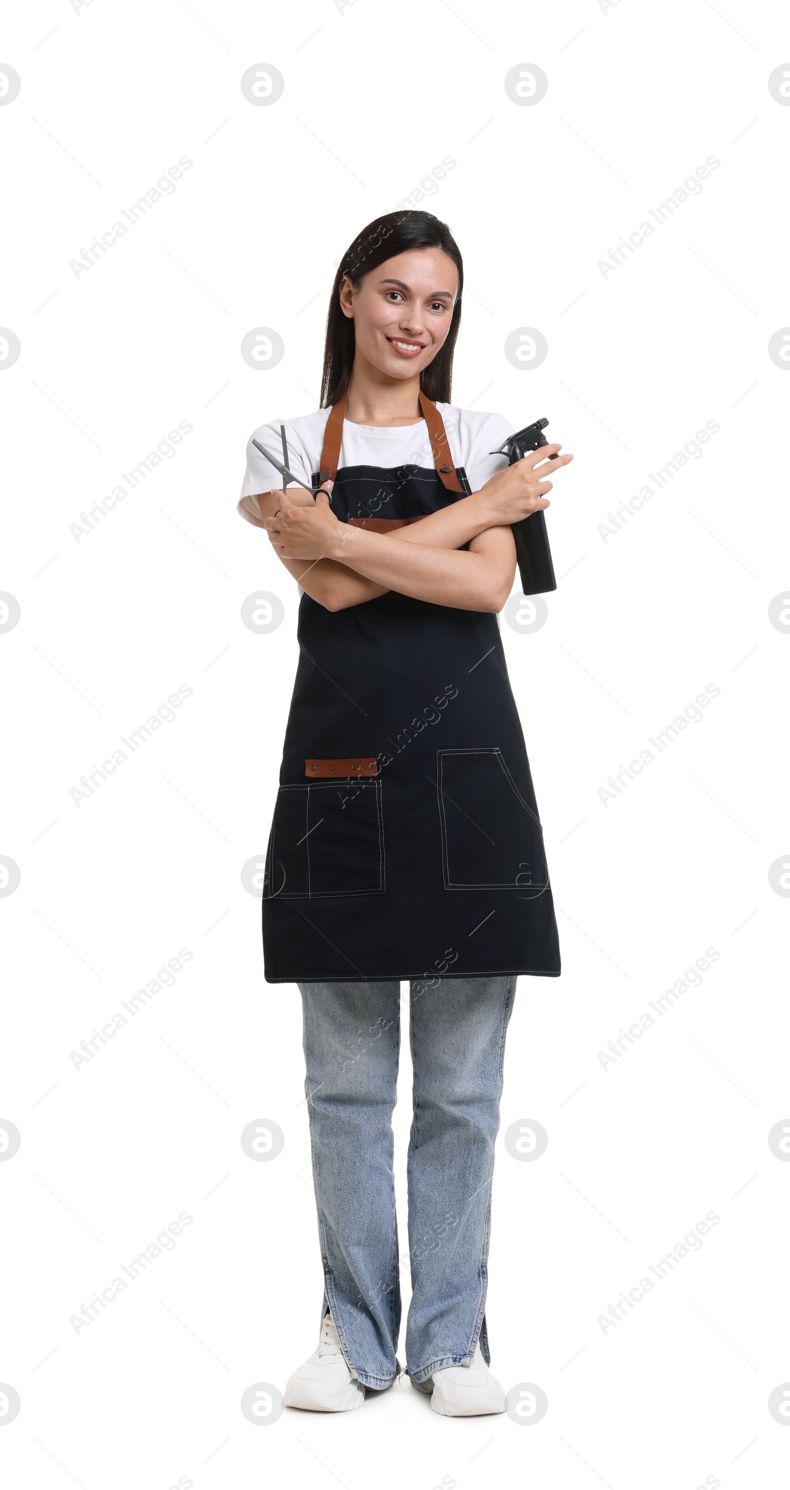 Photo of Hairdresser in apron with scissors and spray bottle on white background
