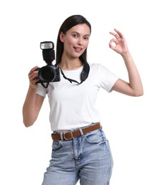 Photo of Portrait of photographer with professional camera showing ok gesture on white background