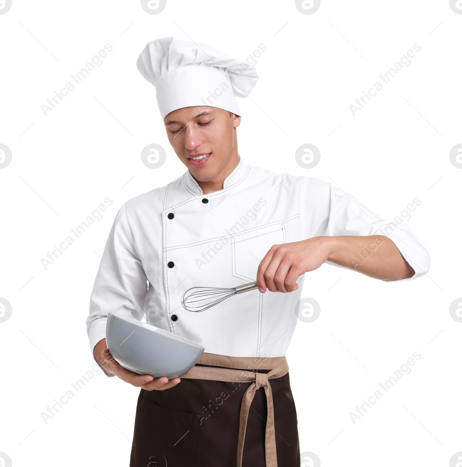 Photo of Portrait of professional chef in uniform with bowl and whisk on white background