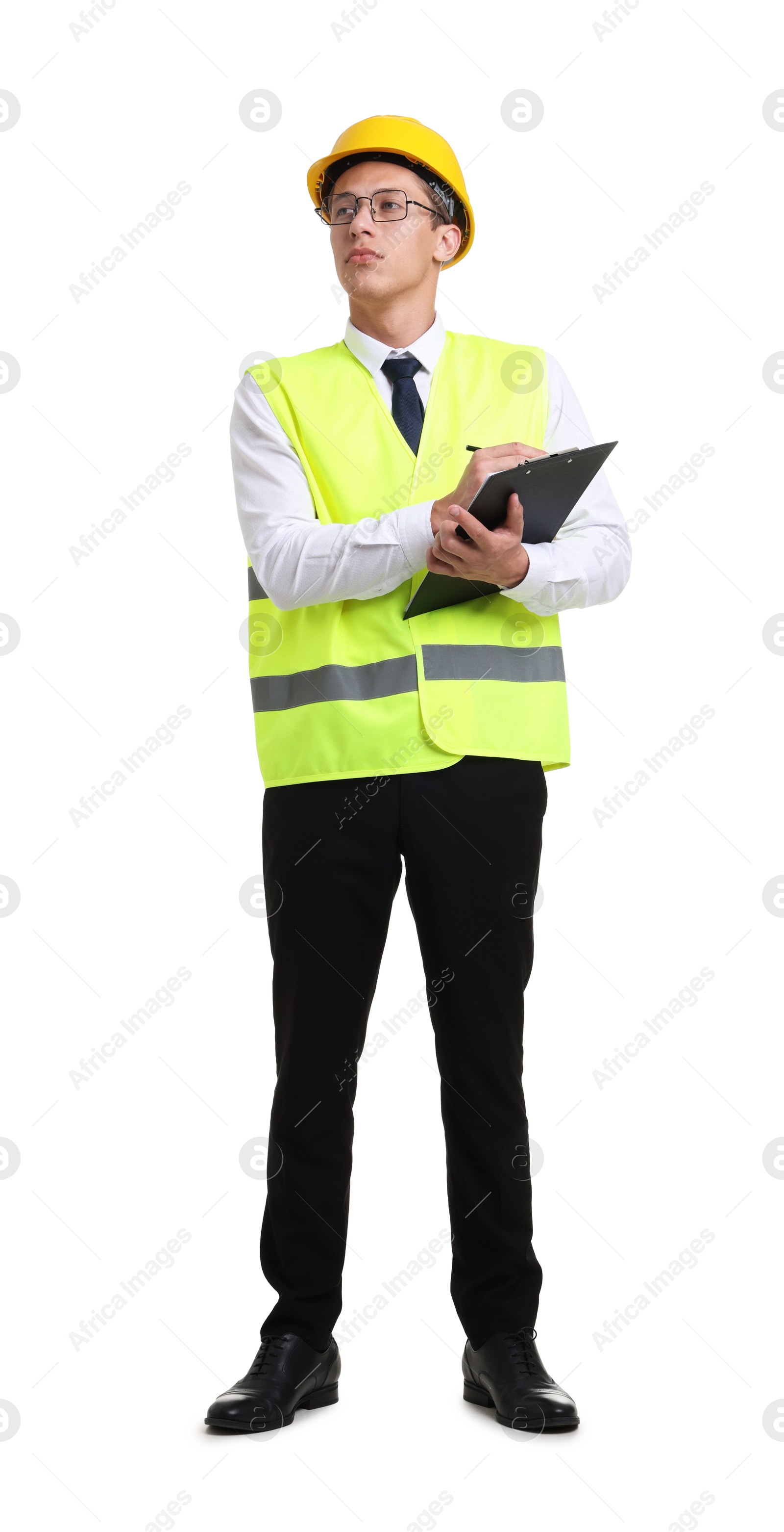 Photo of Young engineer in hard hat and reflective vest with clipboard on white background