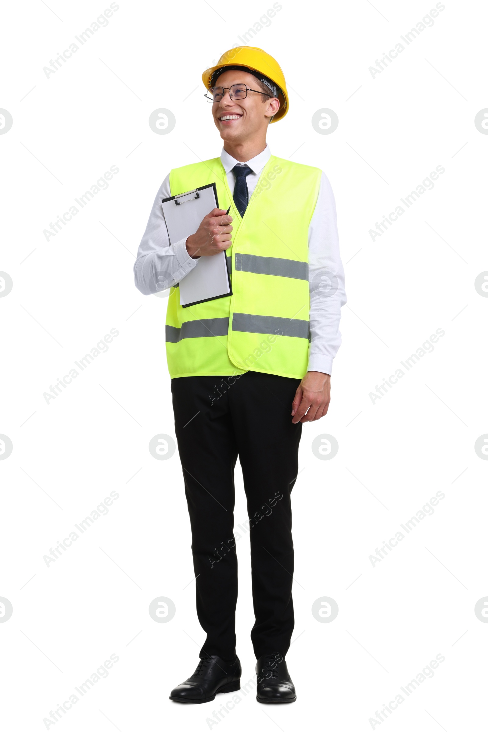 Photo of Young engineer in hard hat and reflective vest with clipboard on white background