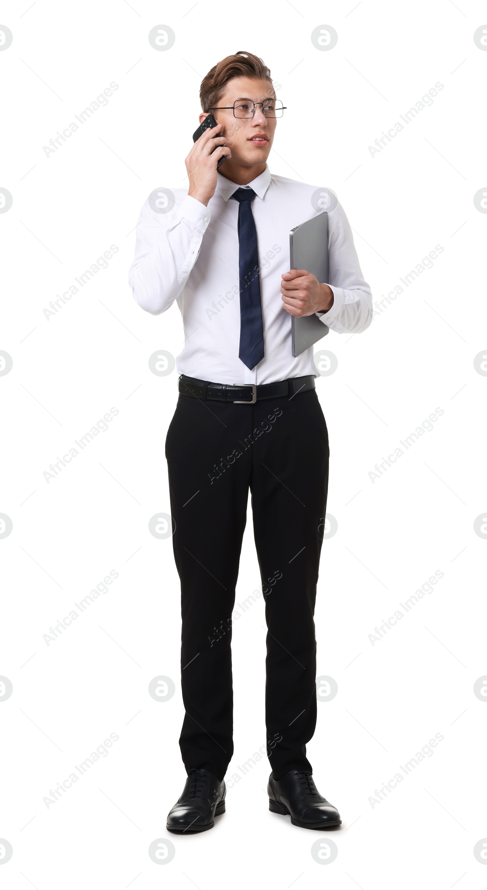 Young businessman with laptop talking on phone on white background Photo of Young businessman with laptop talking on phone on white background