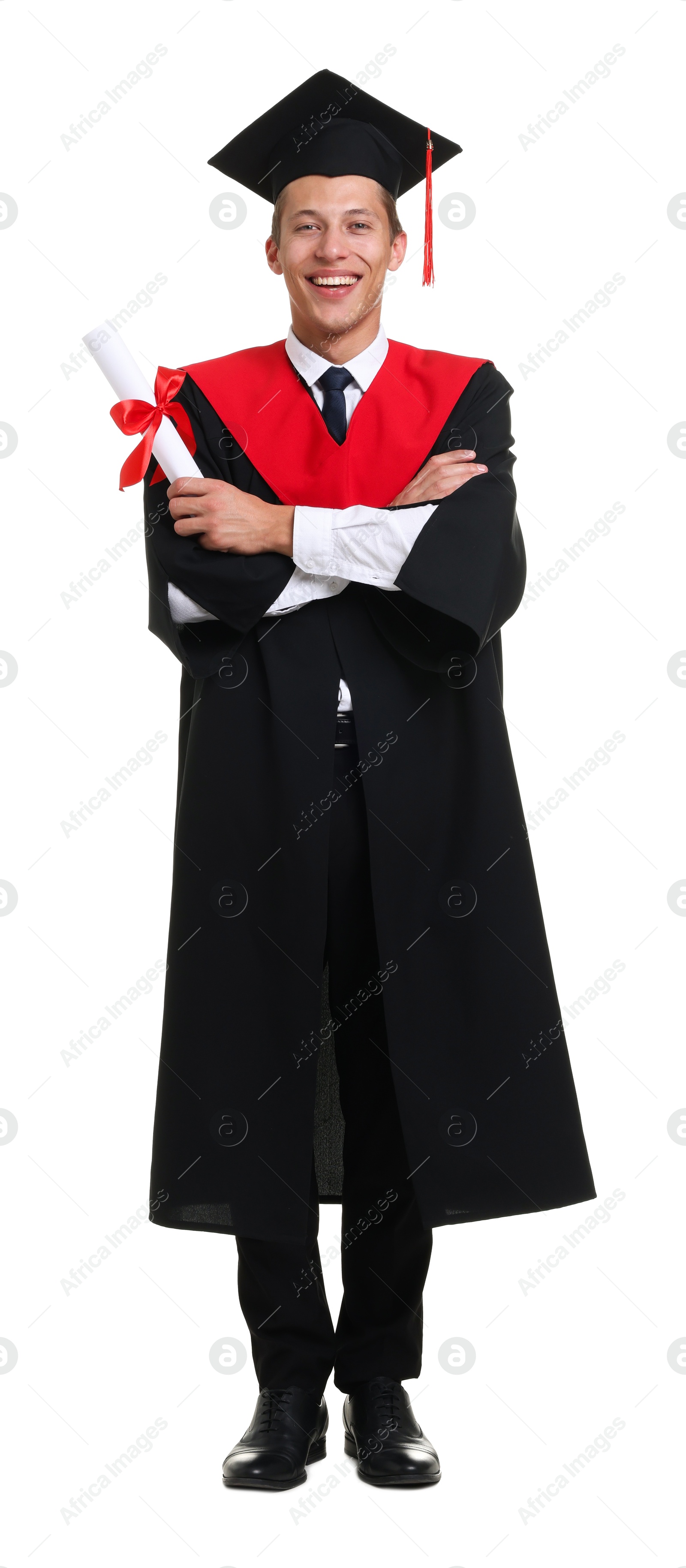 Photo of Happy young man in graduation gown and mortarboard with diploma on white background