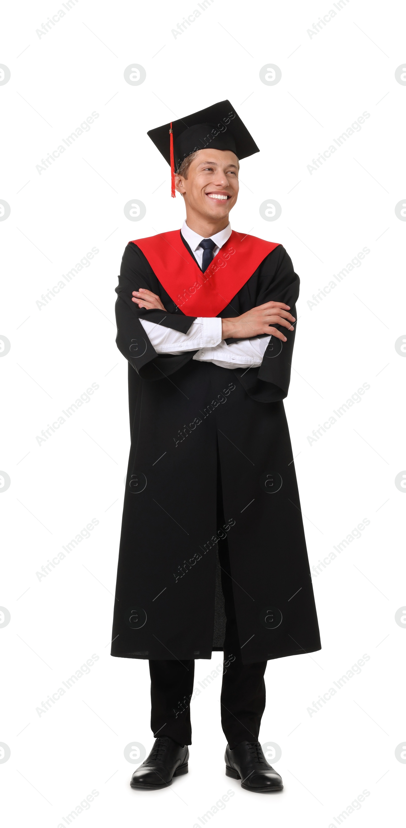 Photo of Young man in graduation gown and mortarboard on white background