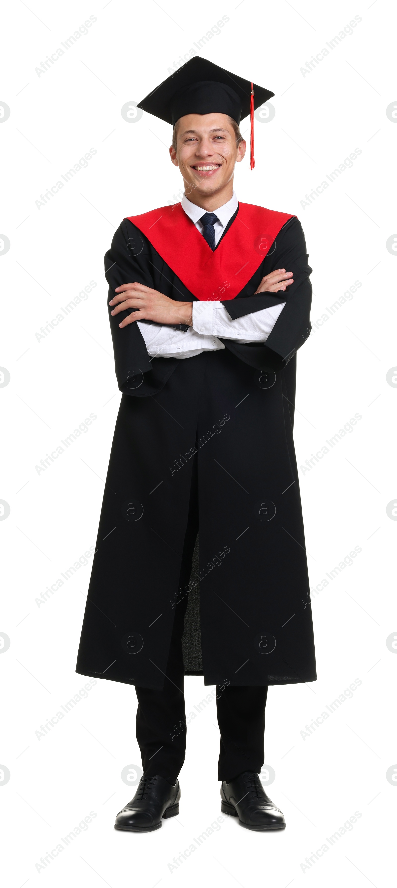 Photo of Young man in graduation gown and mortarboard on white background