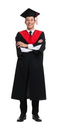 Photo of Young man in graduation gown and mortarboard on white background