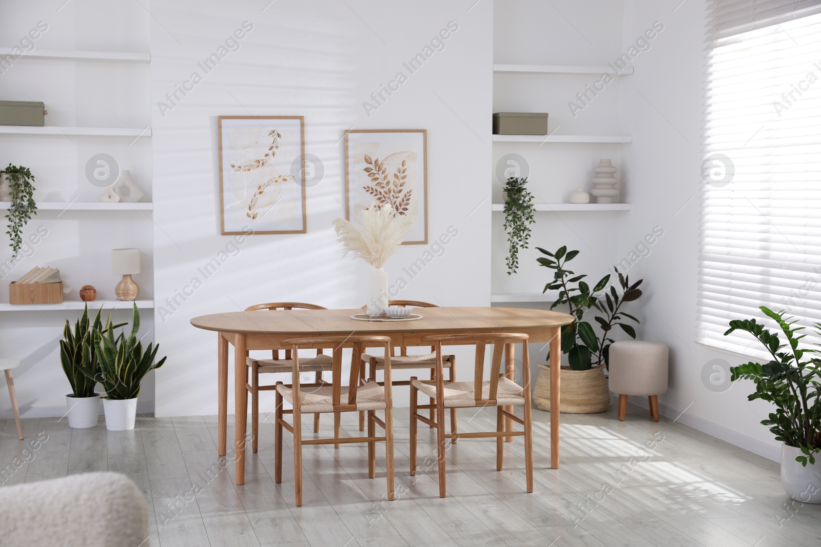 Photo of Stylish wooden table with chairs and decor indoors. Interior design