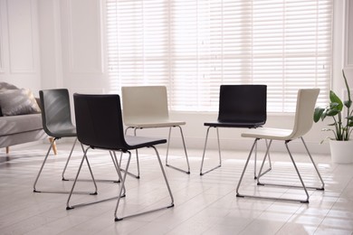 Photo of Chairs in circle prepared for group psychotherapy session indoors
