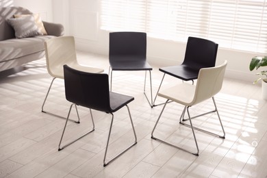 Photo of Chairs in circle prepared for group psychotherapy session indoors