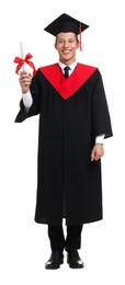 Photo of Happy young man in graduation gown and mortarboard with diploma on white background