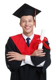 Photo of Portrait of happy young man in graduation gown and mortarboard with diploma on white background