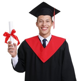 Photo of Portrait of happy young man in graduation gown and mortarboard with diploma on white background