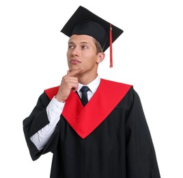 Photo of Portrait of thoughtful man in graduation gown and mortarboard on white background