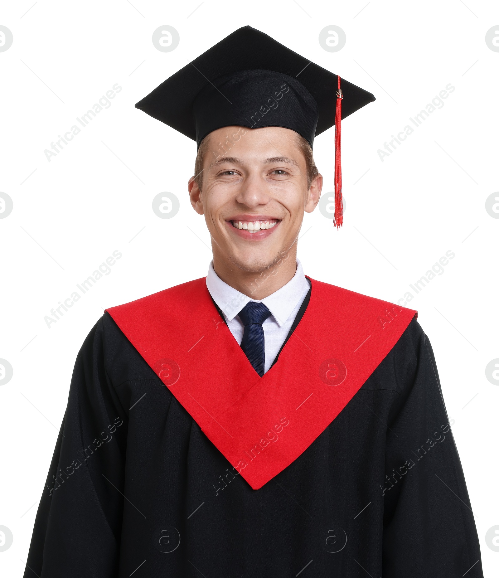 Photo of Portrait of young man in graduation gown and mortarboard on white background