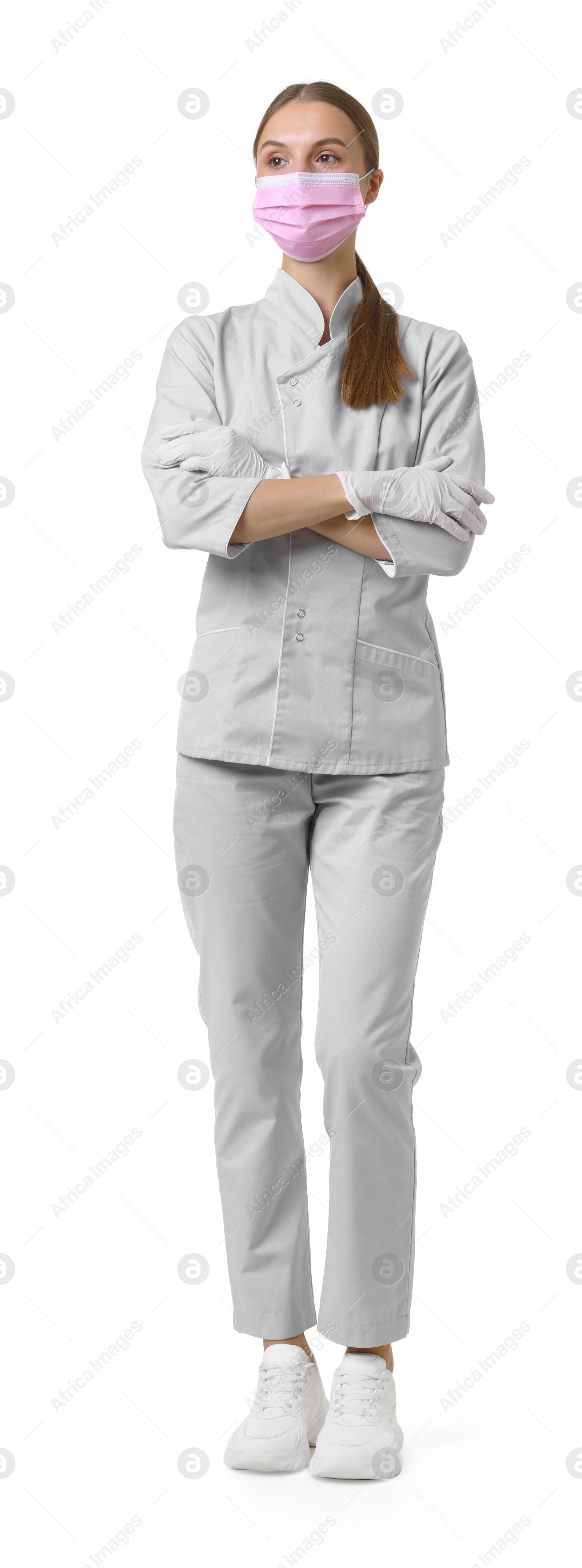 Photo of Full-length portrait of nurse in uniform and medical mask on white background