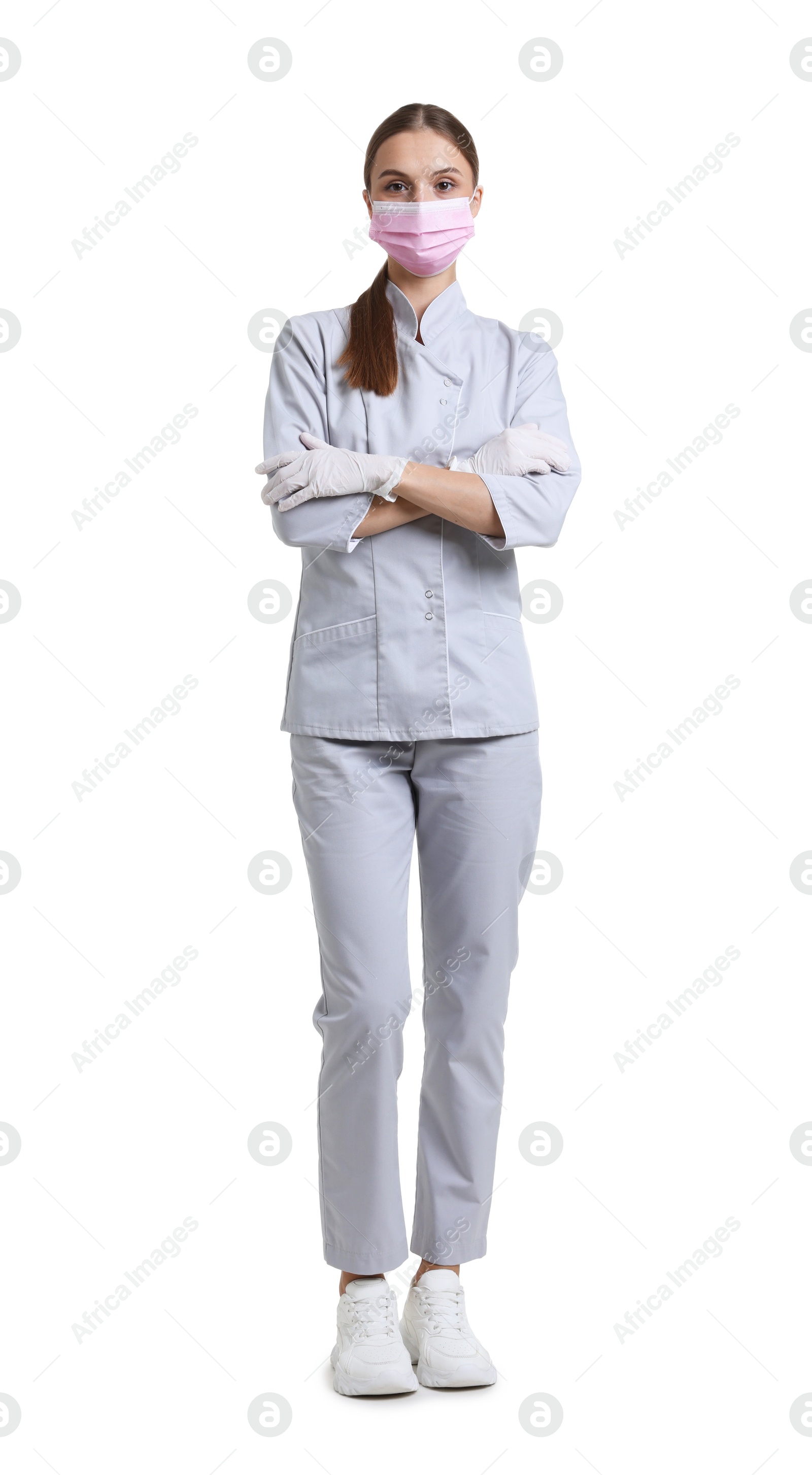 Photo of Full-length portrait of nurse in uniform and medical mask on white background