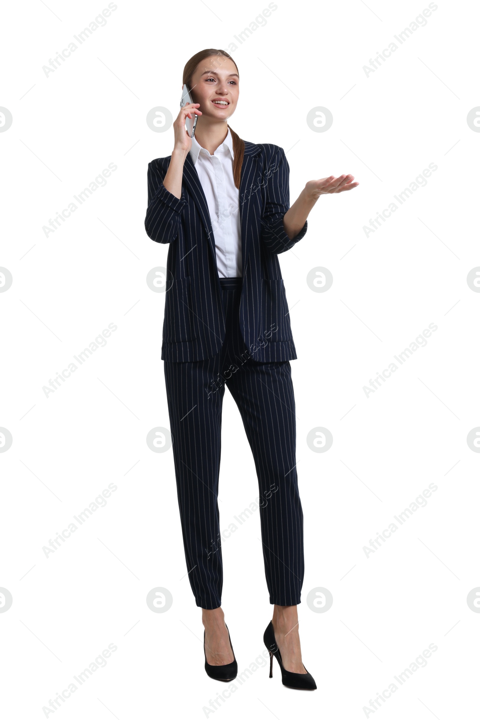 Photo of Young businesswoman in stylish suit talking on phone on white background