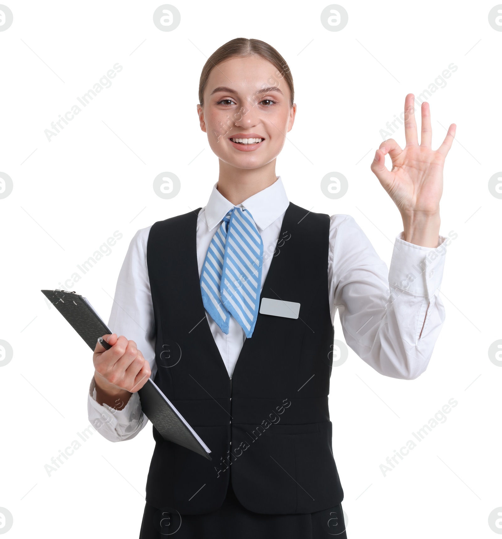 Portrait of stewardess in uniform with clipboard showing ok gesture on white background Photo of Portrait of stewardess in uniform with clipboard showing ok gesture on white background