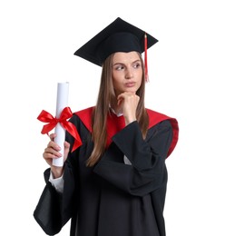 Photo of Portrait of thoughtful young woman in graduation gown and mortarboard with diploma on white background