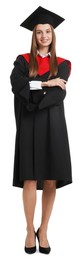 Photo of Happy young woman in graduation gown and mortarboard on white background