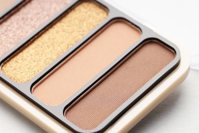 Photo of Beautiful eyeshadow palette on white table, closeup
