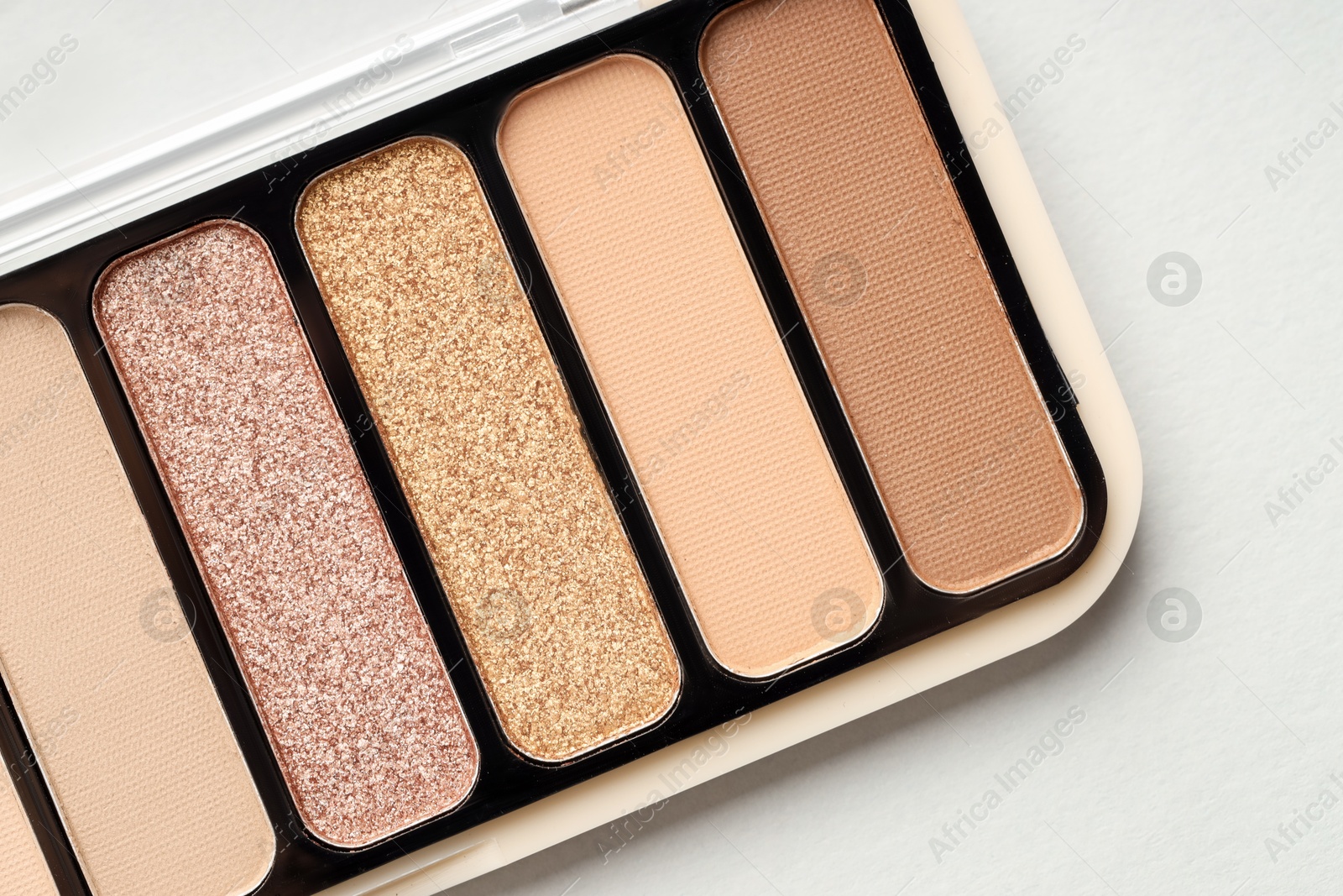 Photo of Beautiful eyeshadow palette on white table, top view