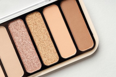 Photo of Beautiful eyeshadow palette on white table, top view