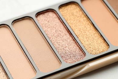 Photo of One beautiful eyeshadow palette on table, closeup