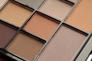 Photo of Beautiful eyeshadow palette as background, closeup. Cosmetic product