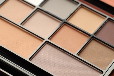Photo of Beautiful eyeshadow palette as background, closeup. Cosmetic product