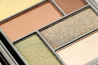 Photo of Beautiful eyeshadow palette as background, closeup. Cosmetic product
