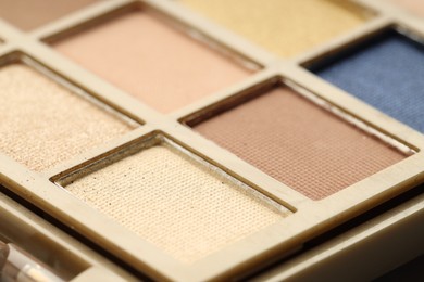 Photo of Beautiful eyeshadow palette as background, closeup. Cosmetic product