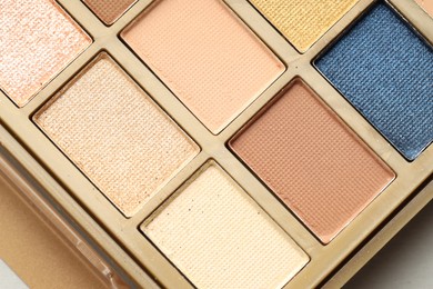 Photo of Beautiful eyeshadow palette on white background, top view